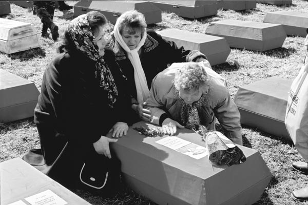 Дочери красноармейца А.Т.Михайлова у гроба с останками отца. Ленинградская область. 2003 год. Фото А.Коноплева.